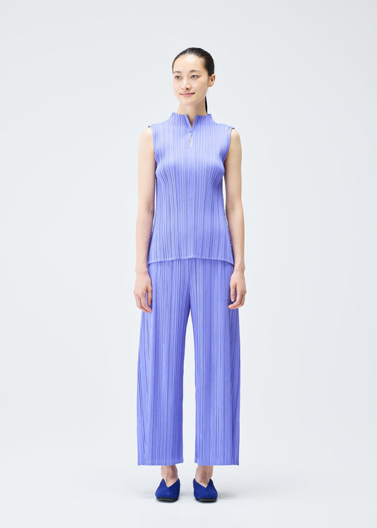 A model wears the PLEATS PLEASE ISSEY MIYAKE MELLOW PLEATS top.