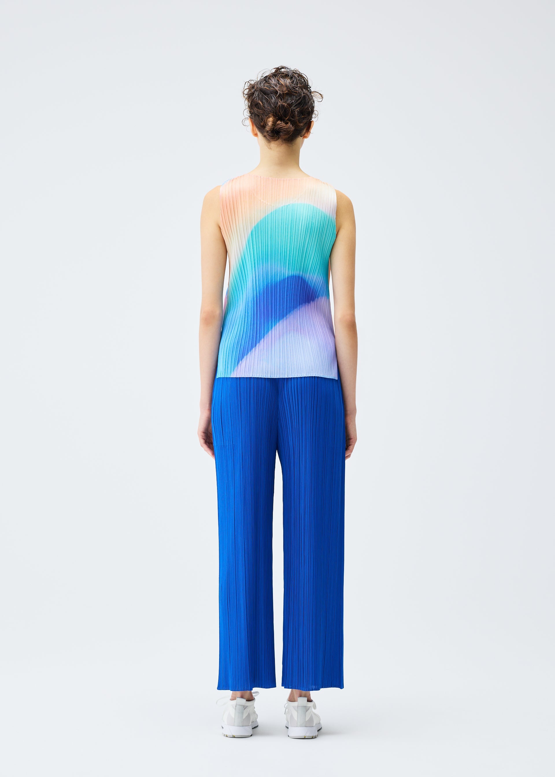 A model wears the PLEATS PLEASE ISSEY MIYAKE GROOVE top.