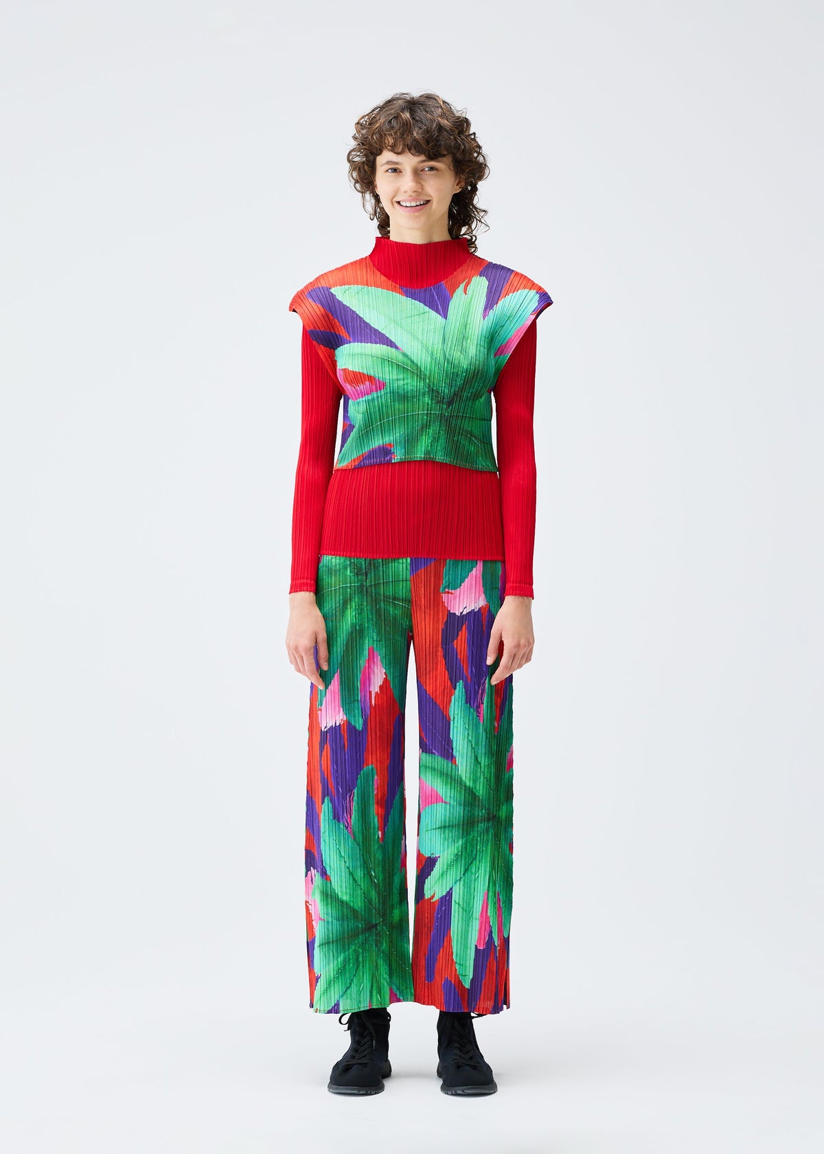 A model wears the PLEATS PLEASE ISSEY MIYAKE CARNIVAL top.
