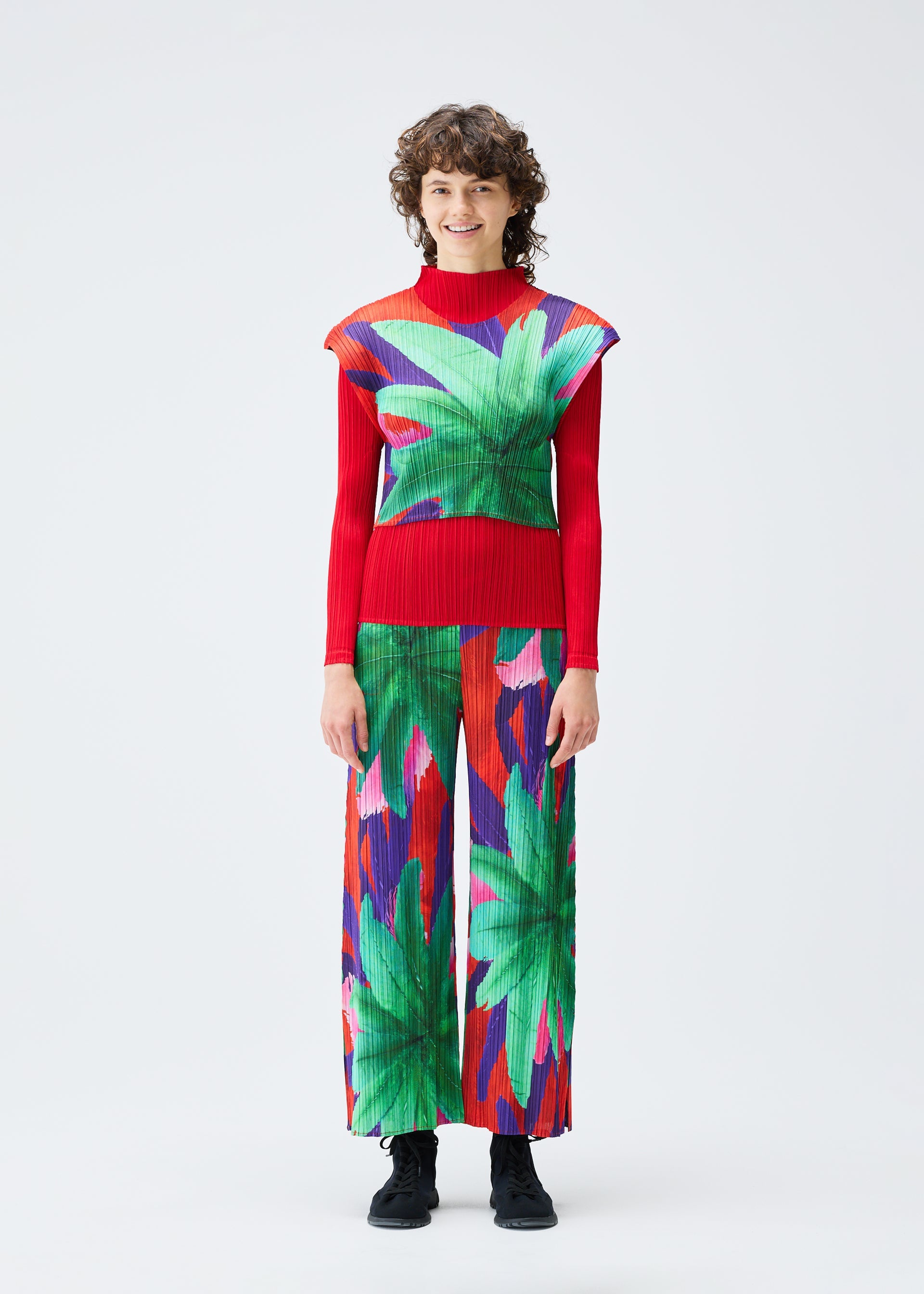 A model wears the PLEATS PLEASE ISSEY MIYAKE CARNIVAL top.