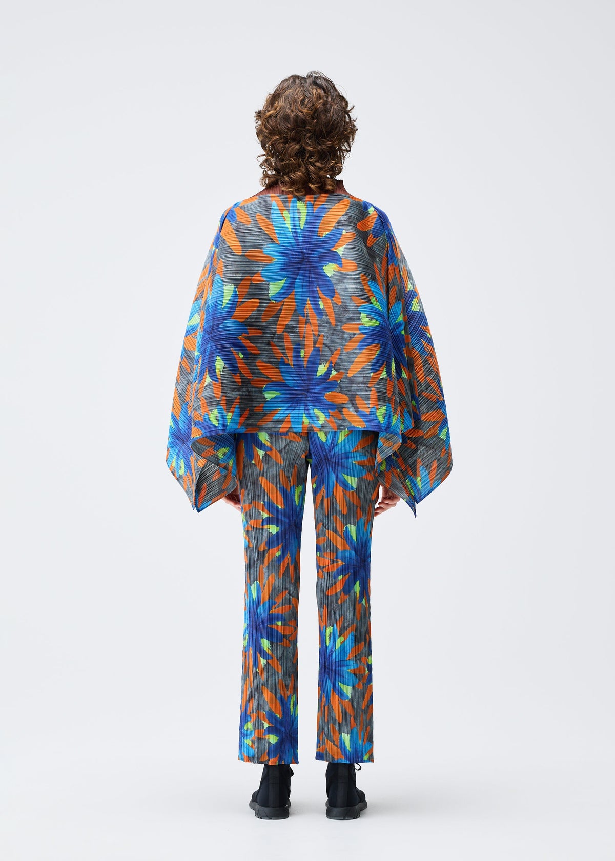 A model wears the PLEATS PLEASE ISSEY MIYAKE CARNIVAL top.