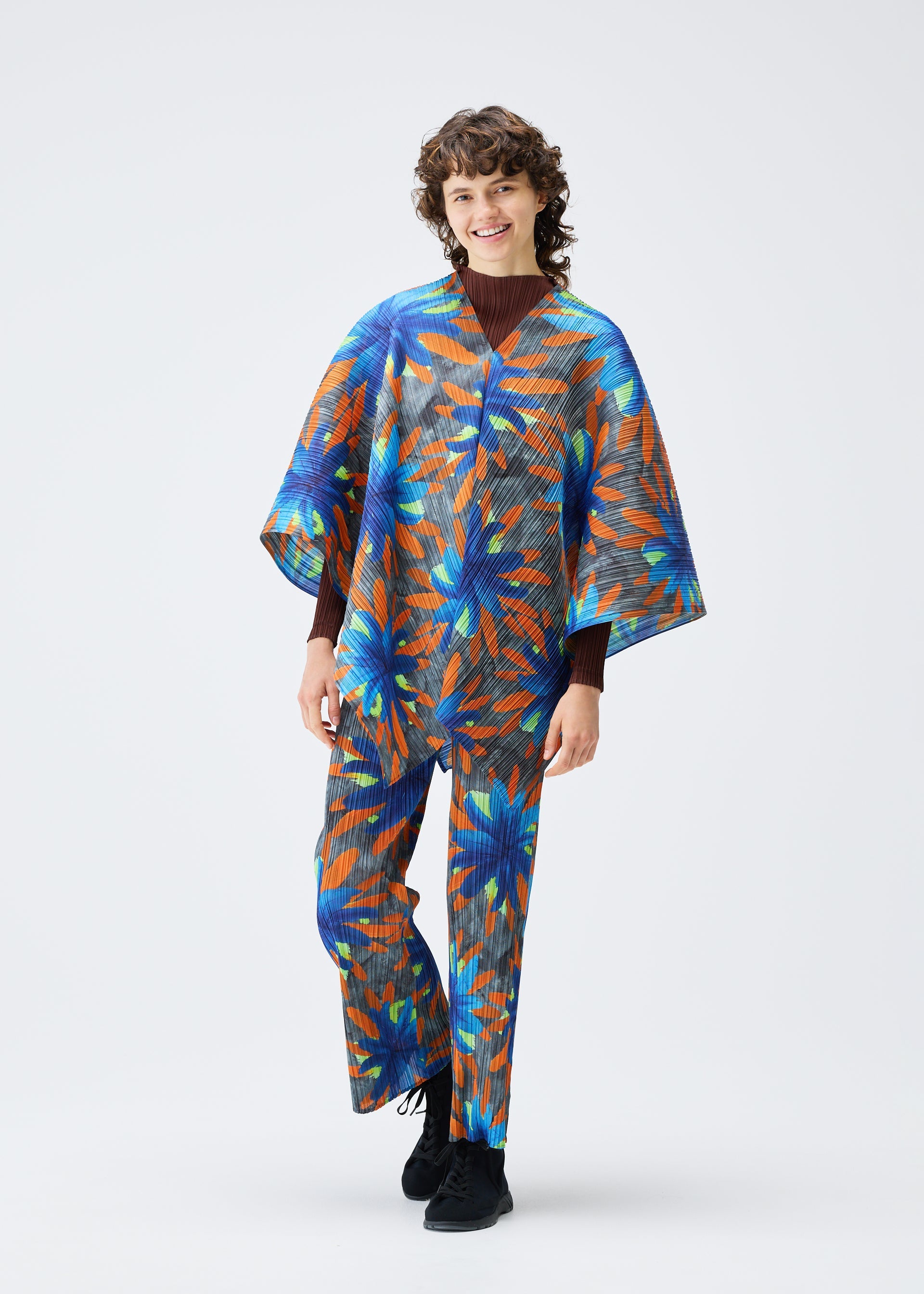 A model wears the PLEATS PLEASE ISSEY MIYAKE CARNIVAL top.