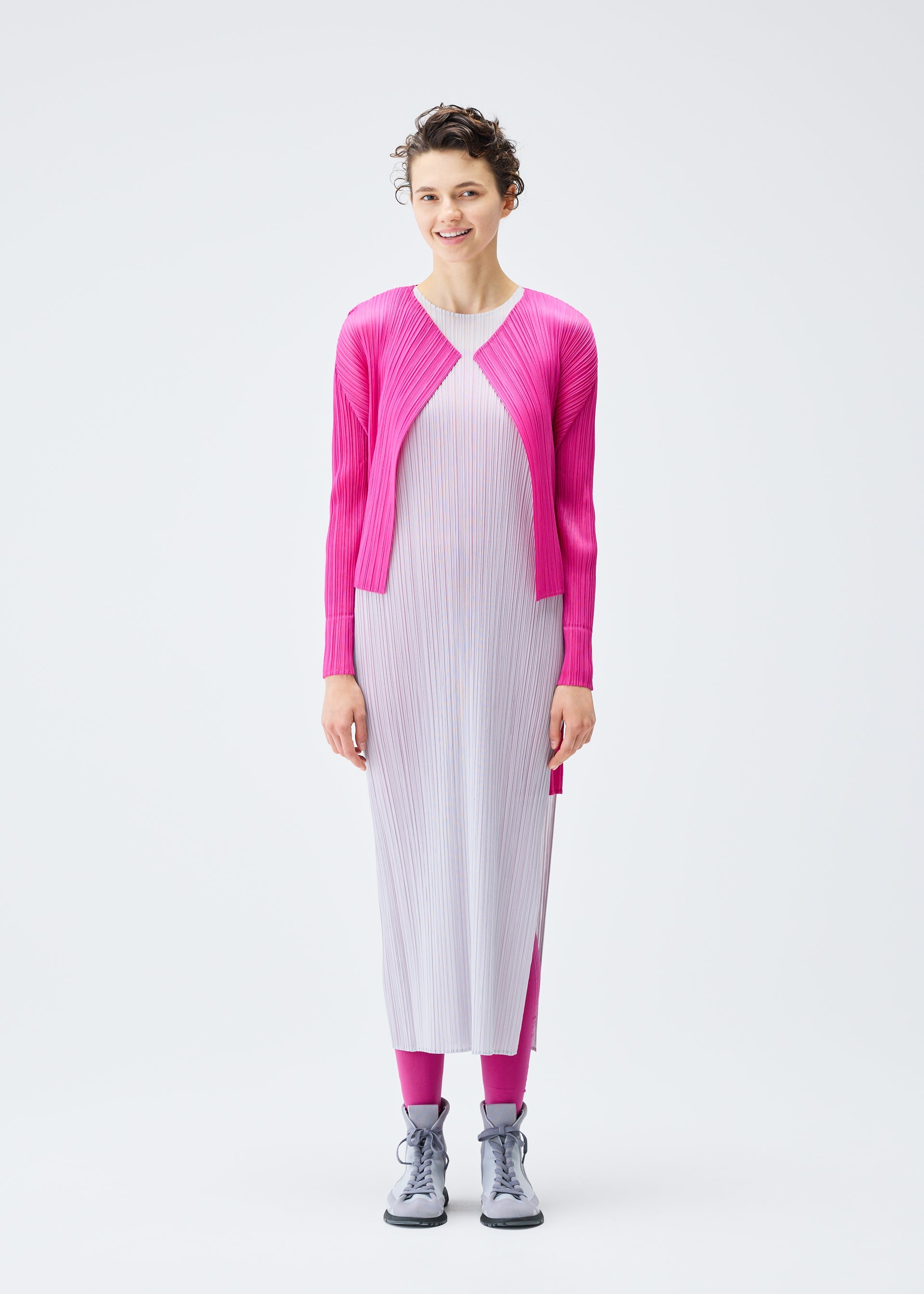A model wears the PLEATS PLEASE ISSEY MIYAKE LUCID PLEATS cardigan.