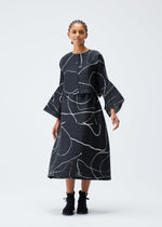 A model wears the PLEATS PLEASE ISSEY MIYAKE PAUSE cardigan.
