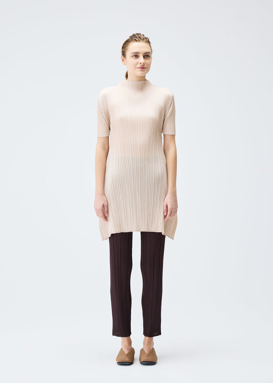 A model wears the PLEATS PLEASE ISSEY MIYAKE MONTHLY COLORS JULY tunic.