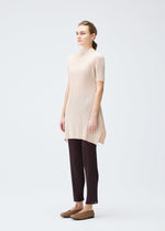 A model wears the PLEATS PLEASE ISSEY MIYAKE MONTHLY COLORS JULY tunic.