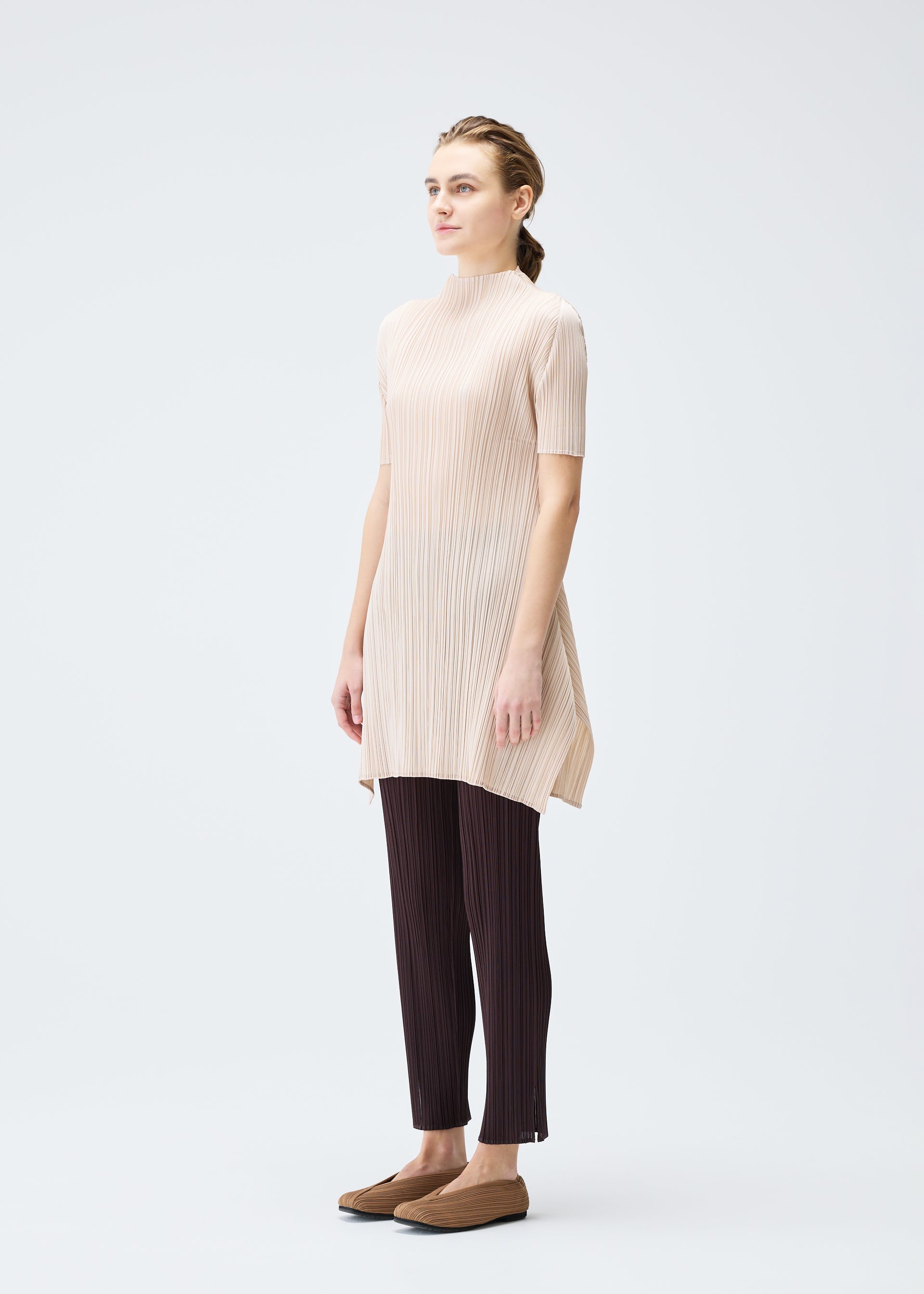 A model wears the PLEATS PLEASE ISSEY MIYAKE MONTHLY COLORS JULY tunic.