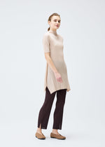 A model wears the PLEATS PLEASE ISSEY MIYAKE MONTHLY COLORS JULY tunic.