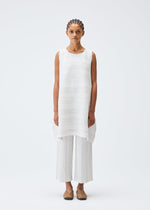 A model wears the PLEATS PLEASE ISSEY MIYAKE COTTON SKIP tunic.