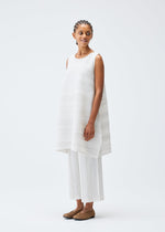 A model wears the PLEATS PLEASE ISSEY MIYAKE COTTON SKIP tunic.