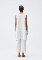 A model wears the PLEATS PLEASE ISSEY MIYAKE COTTON SKIP tunic.