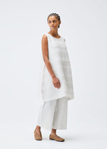 A model wears the PLEATS PLEASE ISSEY MIYAKE COTTON SKIP tunic.