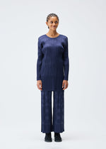 A model wears the PLEATS PLEASE ISSEY MIYAKE TUNE clothing.