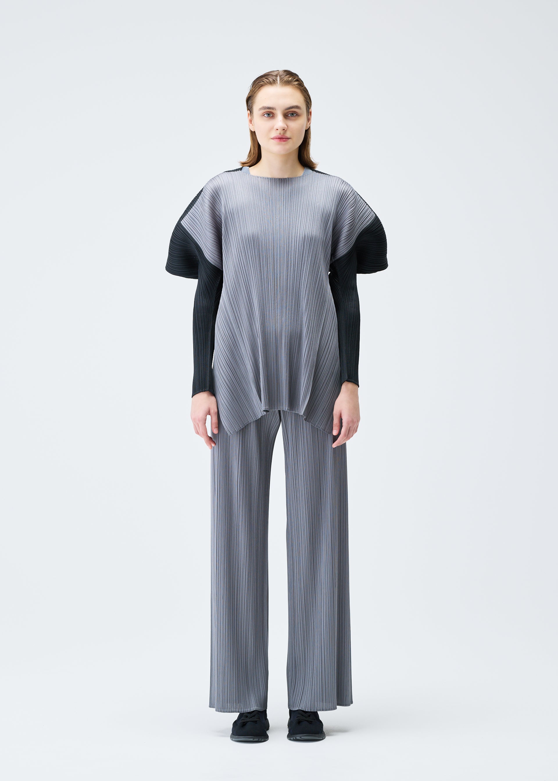 A model wears the PLEATS PLEASE ISSEY MIYAKE SQUARE tunic.