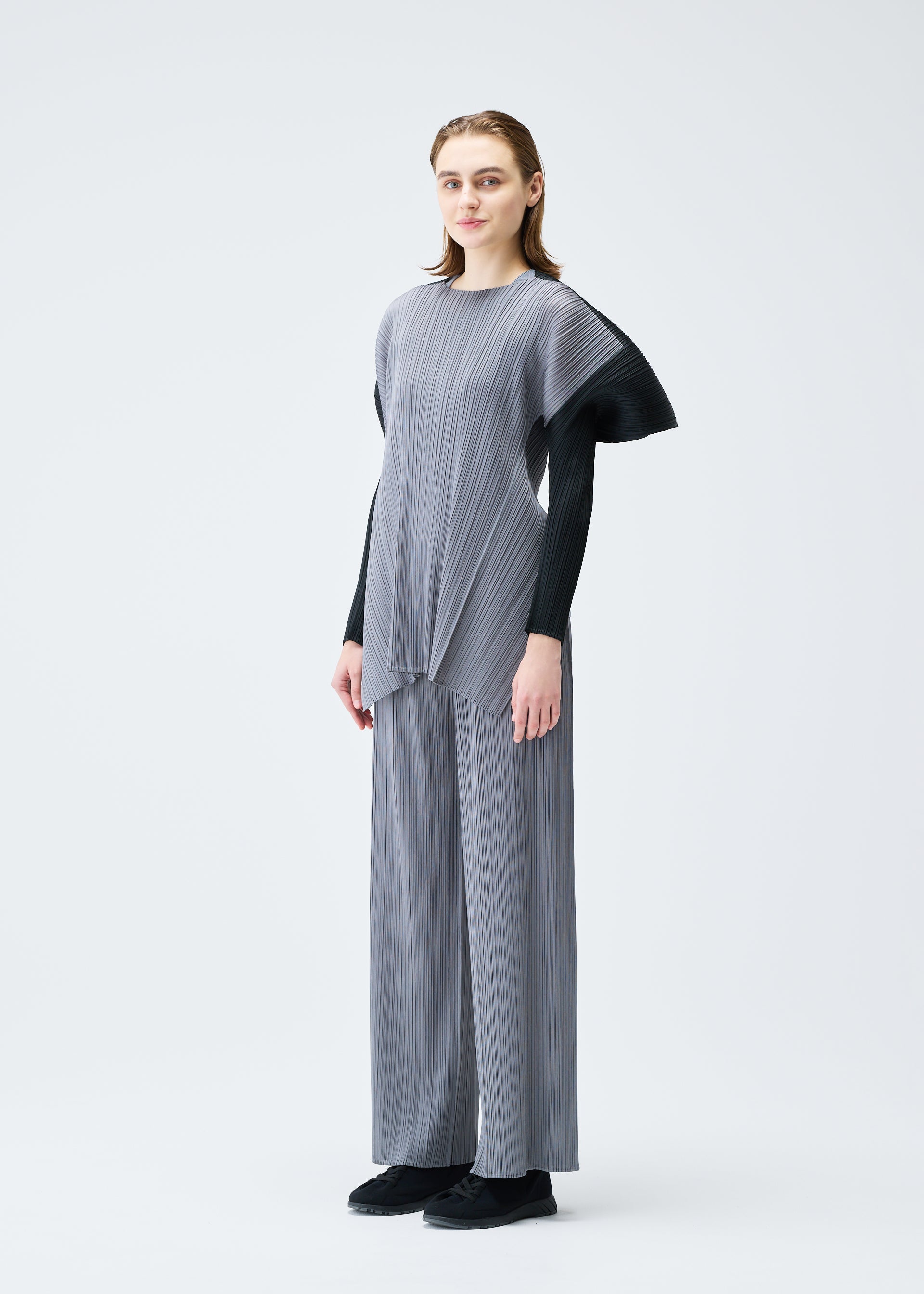 A model wears the PLEATS PLEASE ISSEY MIYAKE SQUARE tunic.