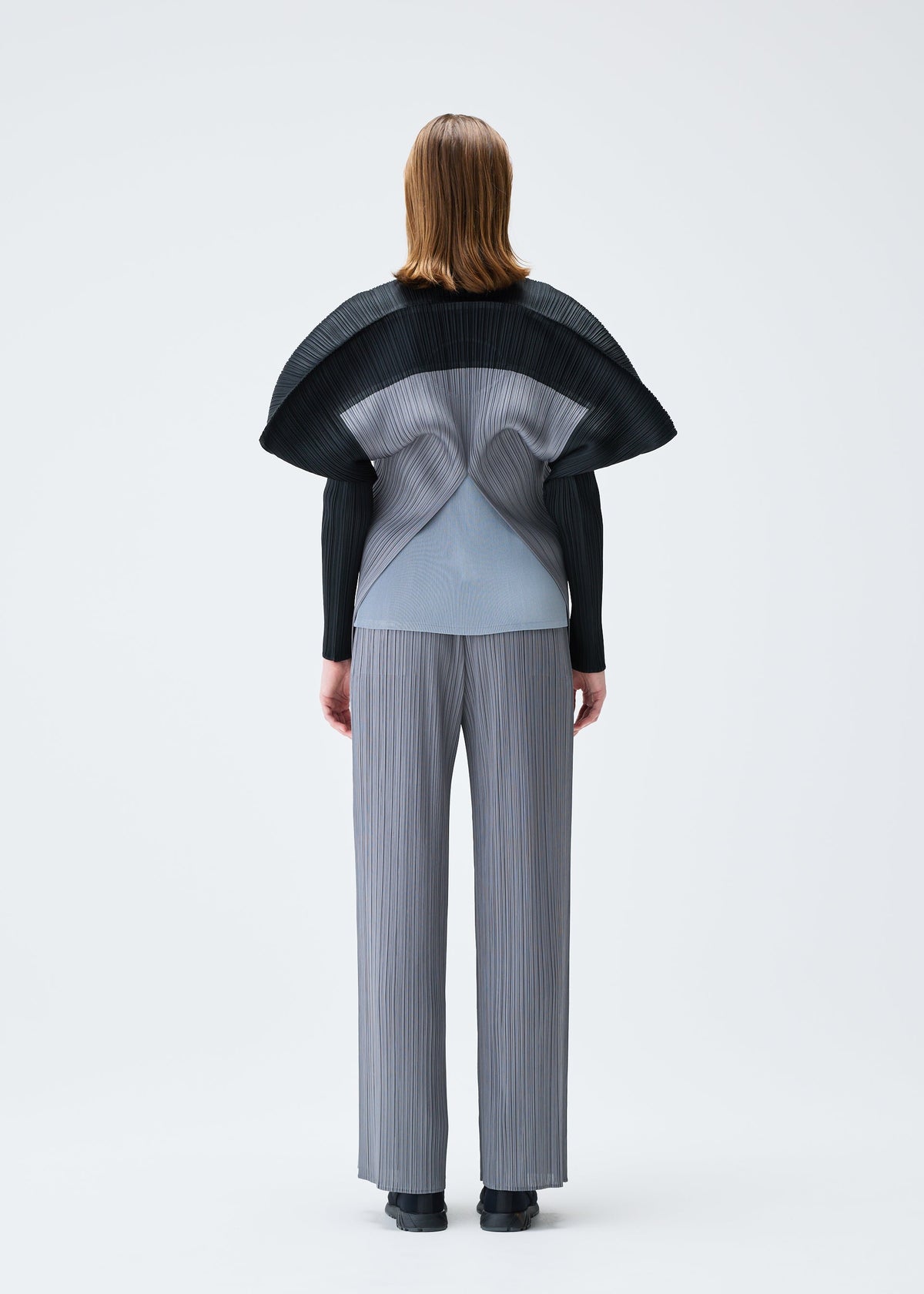 A model wears the PLEATS PLEASE ISSEY MIYAKE SQUARE tunic.