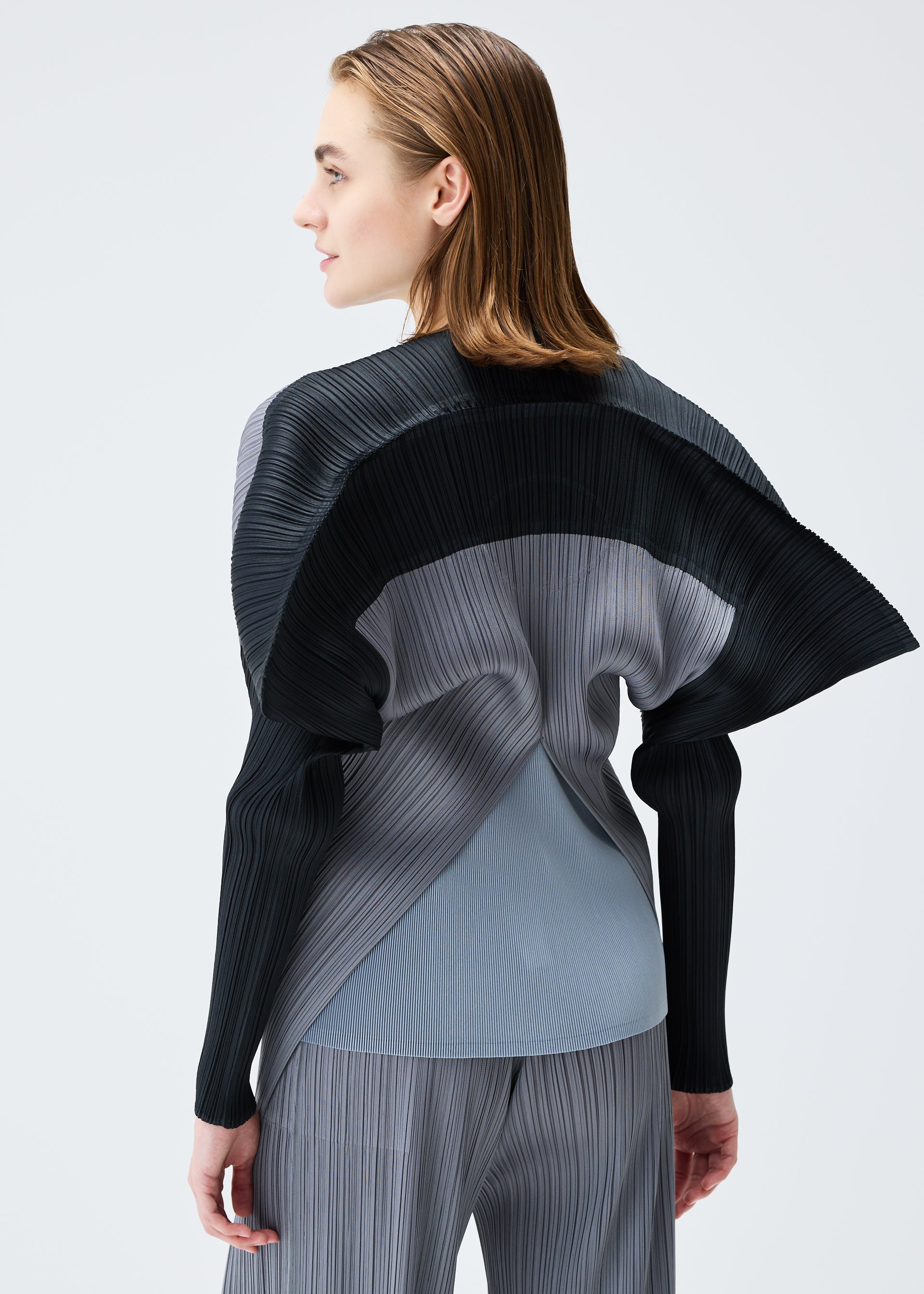 A model wears the PLEATS PLEASE ISSEY MIYAKE SQUARE tunic.