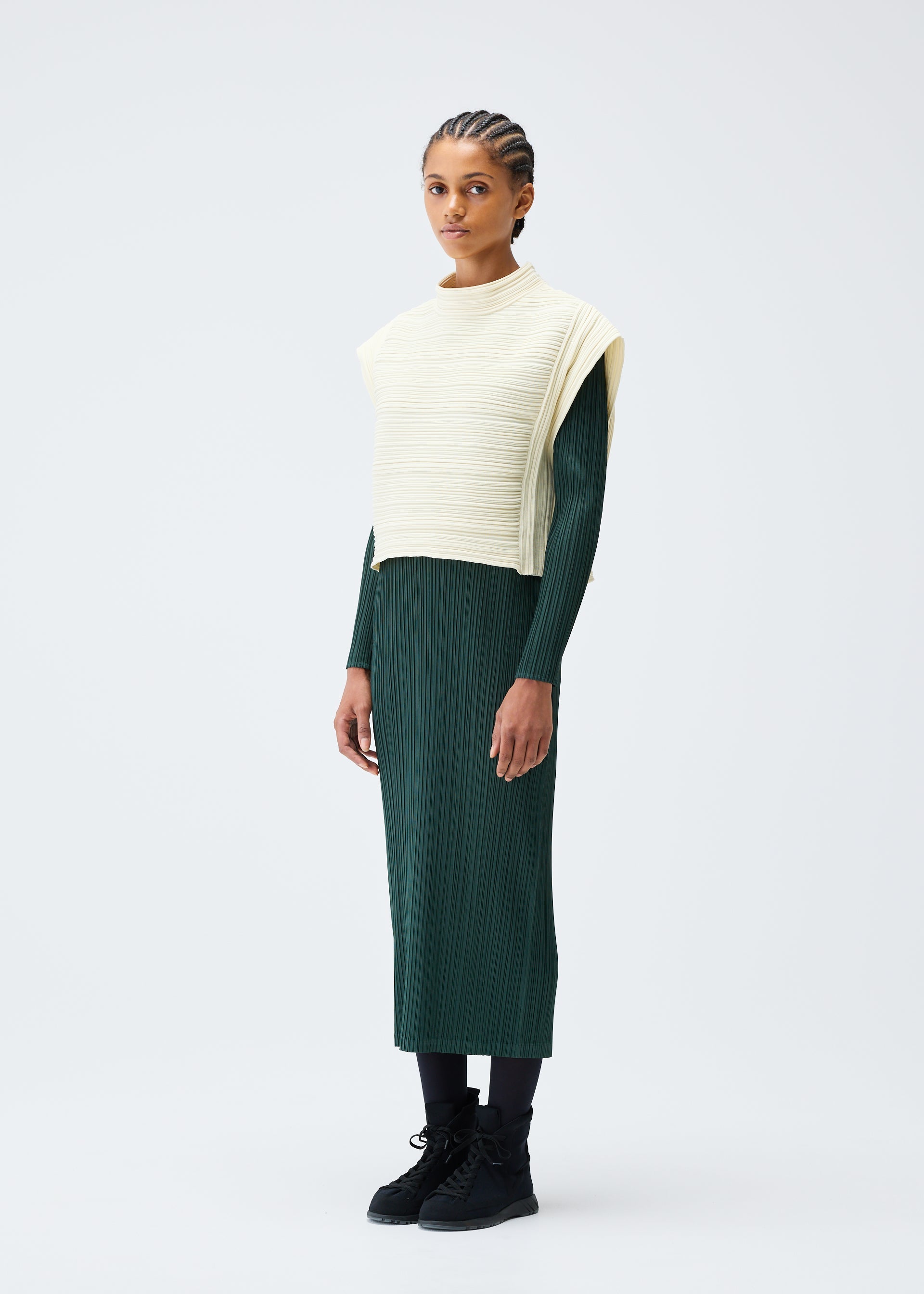 A model wears the PLEATS PLEASE ISSEY MIYAKE CREPE KNIT clothing.