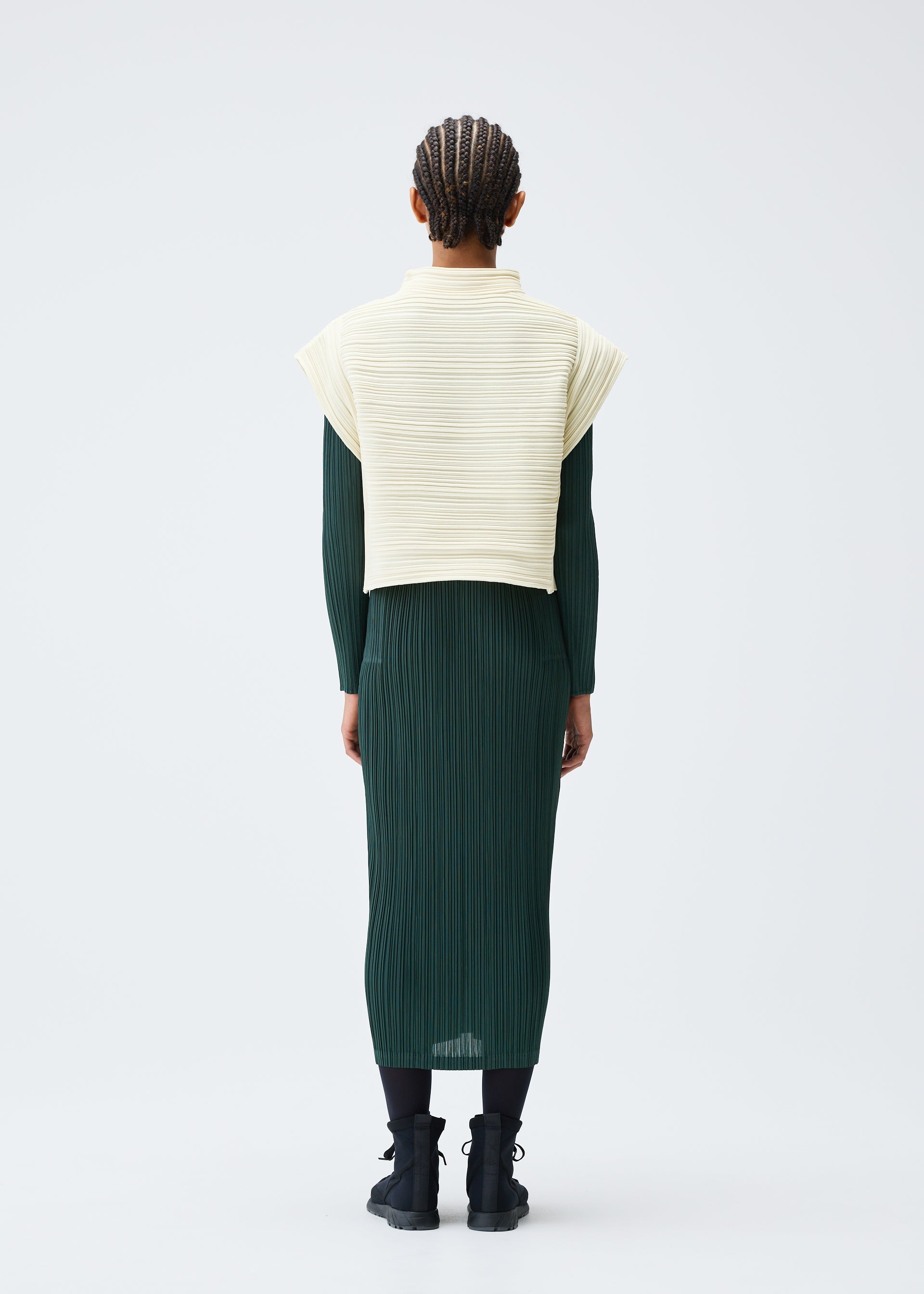A model wears the PLEATS PLEASE ISSEY MIYAKE CREPE KNIT clothing.