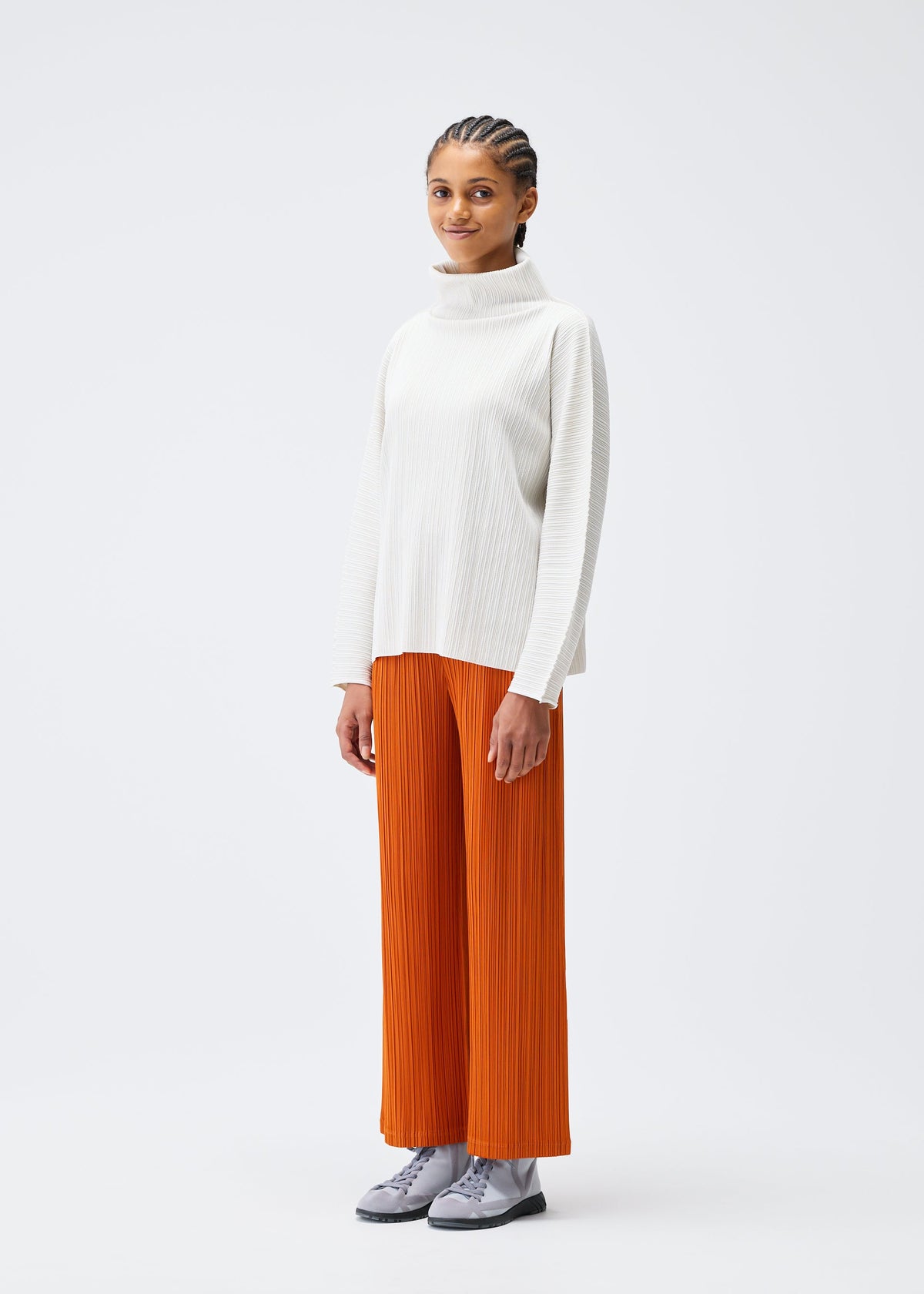 A model wears the PLEATS PLEASE ISSEY MIYAKE A POC SHELL clothing.