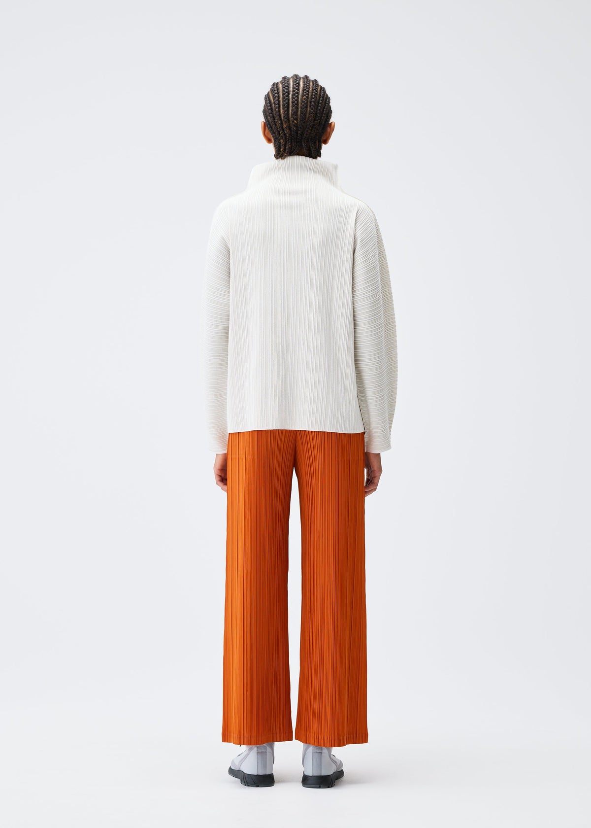 A model wears the PLEATS PLEASE ISSEY MIYAKE A POC SHELL clothing.