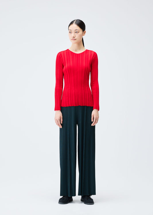 A model wears the PLEATS PLEASE ISSEY MIYAKE RIB KNIT top.