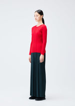 A model wears the PLEATS PLEASE ISSEY MIYAKE RIB KNIT top.