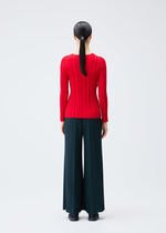A model wears the PLEATS PLEASE ISSEY MIYAKE RIB KNIT top.