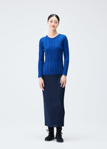 A model wears the PLEATS PLEASE ISSEY MIYAKE RIB KNIT top.