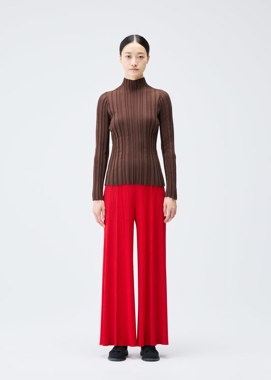 A model wears the PLEATS PLEASE ISSEY MIYAKE RIB KNIT top.