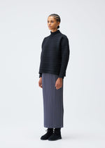 A model wears the PLEATS PLEASE ISSEY MIYAKE CREPE KNIT clothing.