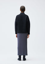 A model wears the PLEATS PLEASE ISSEY MIYAKE CREPE KNIT clothing.