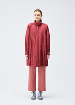A model wears the PLEATS PLEASE ISSEY MIYAKE PADDED PLEATS COAT coat.