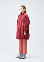 A model wears the PLEATS PLEASE ISSEY MIYAKE PADDED PLEATS COAT coat.