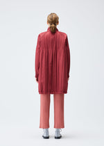 A model wears the PLEATS PLEASE ISSEY MIYAKE PADDED PLEATS COAT coat.