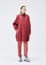 A model wears the PLEATS PLEASE ISSEY MIYAKE PADDED PLEATS COAT coat.