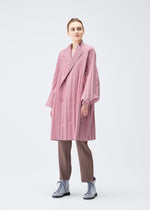 A model wears the PLEATS PLEASE ISSEY MIYAKE SMOOTH COAT coat.