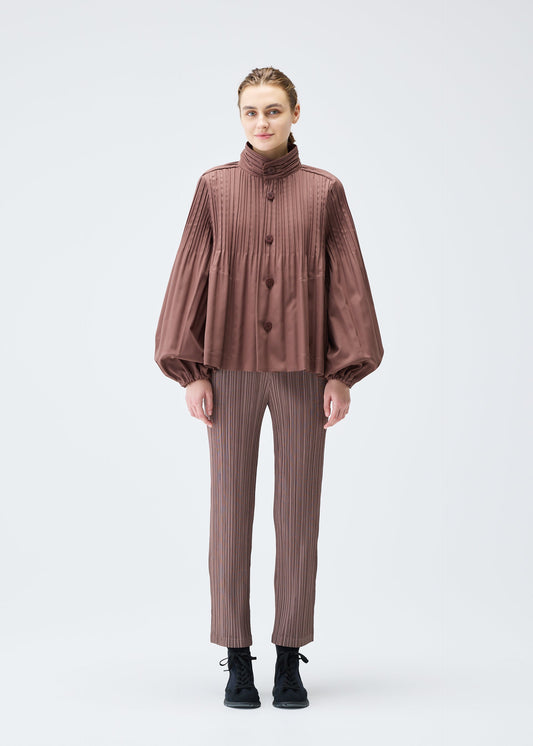 A model wears the PLEATS PLEASE ISSEY MIYAKE SMOOTH COAT jacket.
