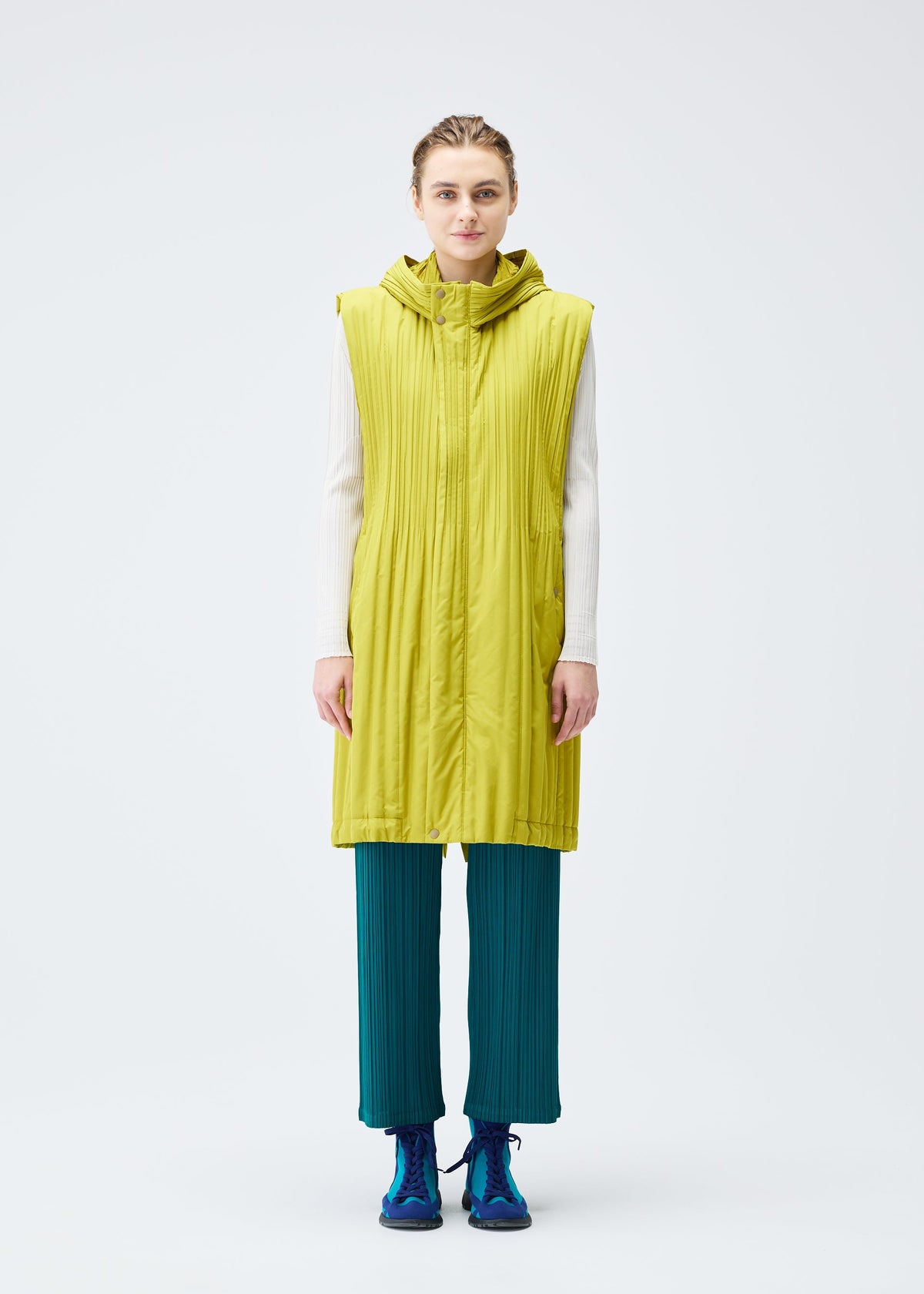 A model wears the PLEATS PLEASE ISSEY MIYAKE PADDED PLEATS COAT vest.
