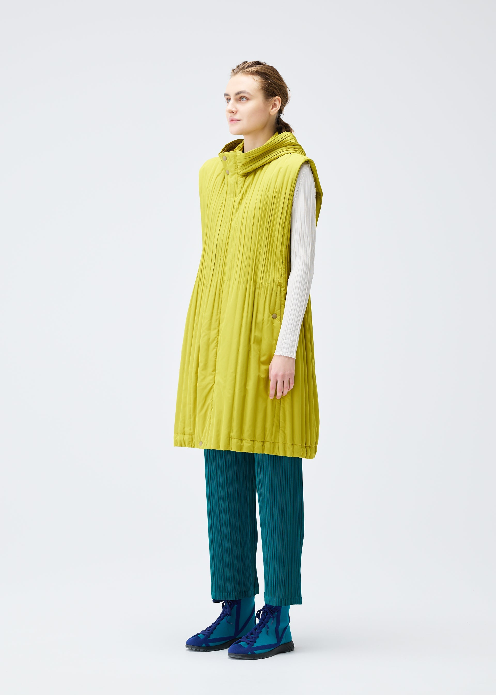 A model wears the PLEATS PLEASE ISSEY MIYAKE PADDED PLEATS COAT vest.