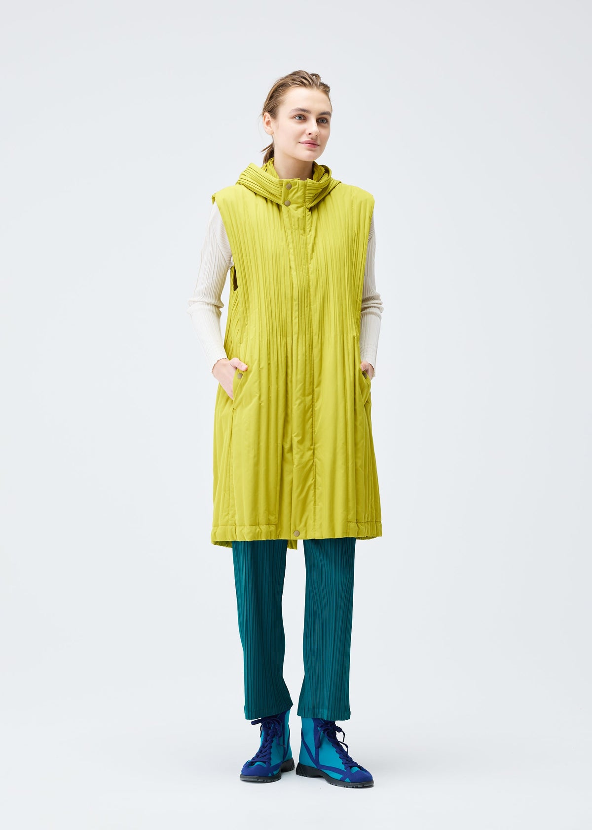 A model wears the PLEATS PLEASE ISSEY MIYAKE PADDED PLEATS COAT vest.