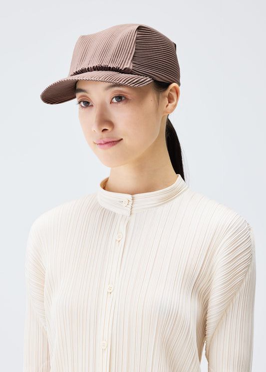 A model wears the PLEATS PLEASE ISSEY MIYAKE PLEATS CAP hat.