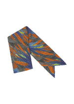 A product shot of the PLEATS PLEASE ISSEY MIYAKE CARNIVAL SCARF stole in grey (12).
