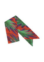A product shot of the PLEATS PLEASE ISSEY MIYAKE CARNIVAL SCARF stole in red (24).