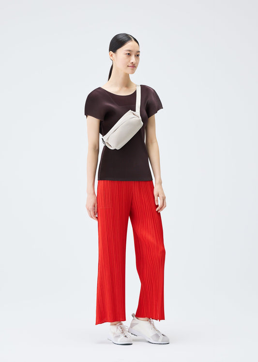 A model wears the PLEATS PLEASE ISSEY MIYAKE BIAS PLEATS WAISTBAG bag.