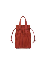 A product shot of the PLEATS PLEASE ISSEY MIYAKE PLEATS TOTE BAG bag in red (24).