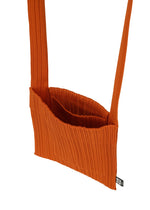 A detail shot of the PLEATS PLEASE ISSEY MIYAKE CREPE KNIT BAG bags.