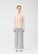 A model wears the PLEATS PLEASE ISSEY MIYAKE TWISTED BORDER SHIRT shirt.