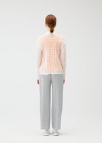 A model wears the PLEATS PLEASE ISSEY MIYAKE TWISTED BORDER SHIRT shirt.