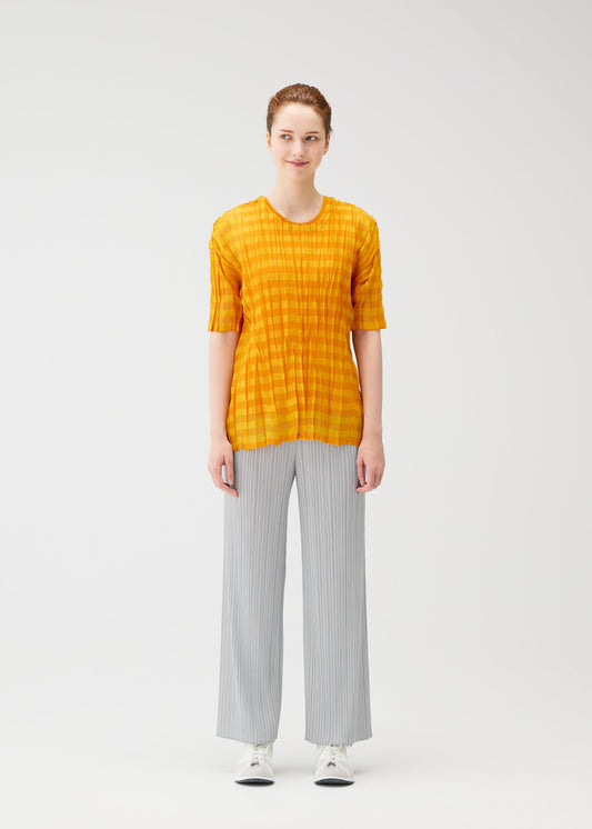 A model wears the PLEATS PLEASE ISSEY MIYAKE TWISTED BORDER SHIRT shirt.